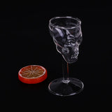 empty skull wine glass and fruit