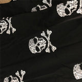 skull print pajama pants black fabric close up