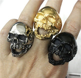 evil skull rings on fingers