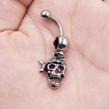 skull belly button ring in hand